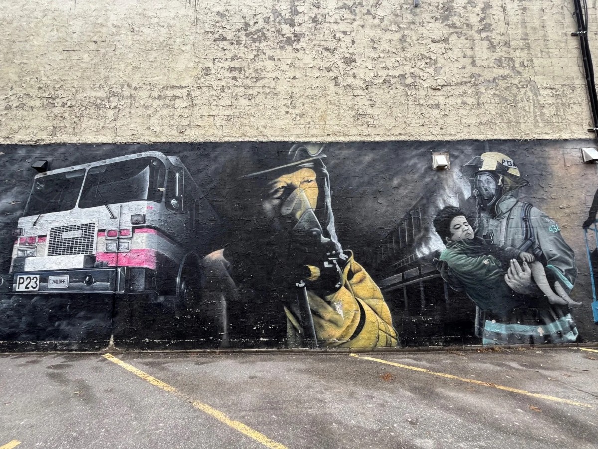 Outdoor mural by Ottawa artist Shaun McInnis on Richmond Road in Westboro, depicting firefighters and a fire truck as a tribute to Ottawa's firefighting history.