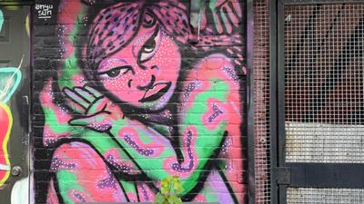 The Contortionist 2.0 mural by Anyu Sun at Arlington Five in Ottawa, showing a pink female figure bent into an impossible contortionist shape against a bright colourful background, 2024.