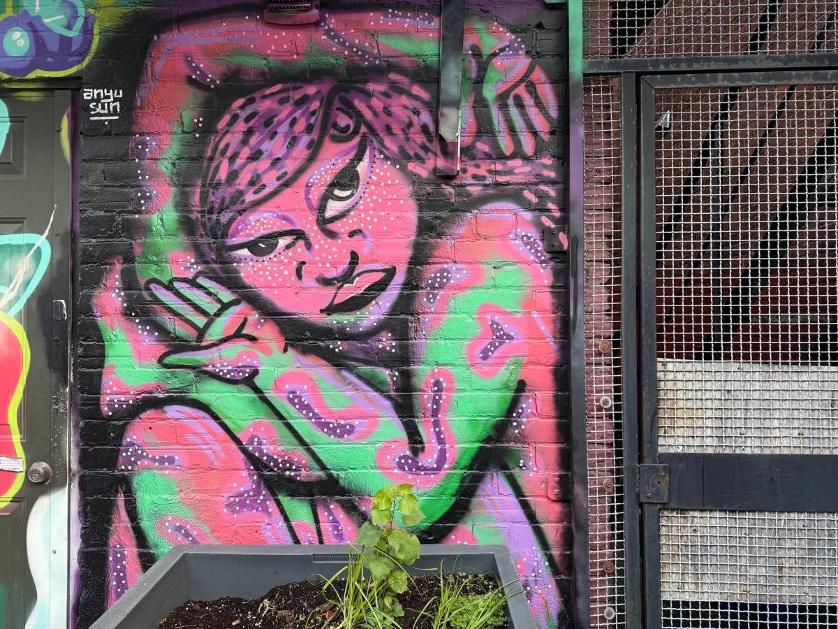 Detail of The Contortionist 2.0 mural by Anyu Sun at Arlington Five in Ottawa, showing the expressive colours and form of a pink contortionist figure pushing against societal expectations, 2024