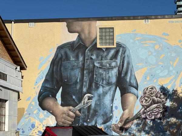 Ryan Smeeton's Street Art Mural for Ottawa's Wellington West depicting a faceless figure with a wrench