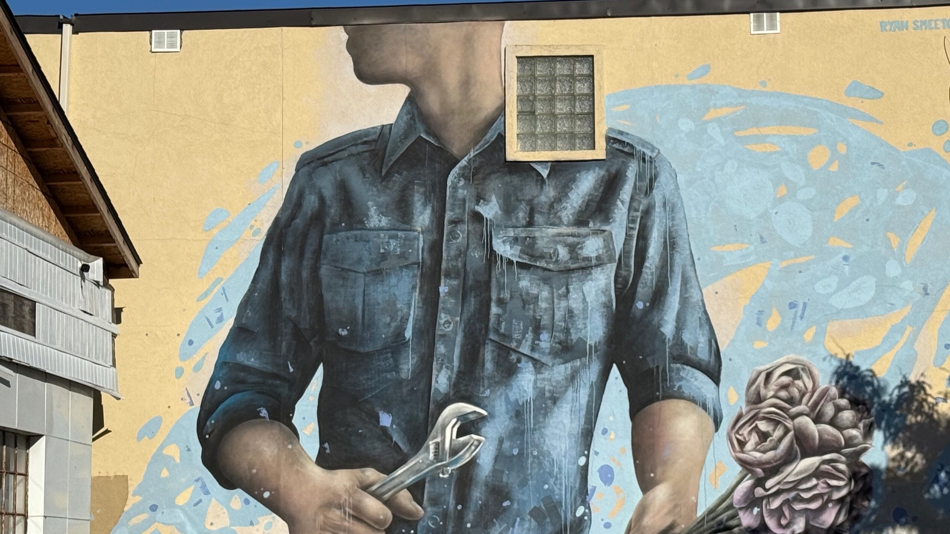 Ryan Smeeton's Street Art Mural for Ottawa's Wellington West depicting a faceless figure with a wrench