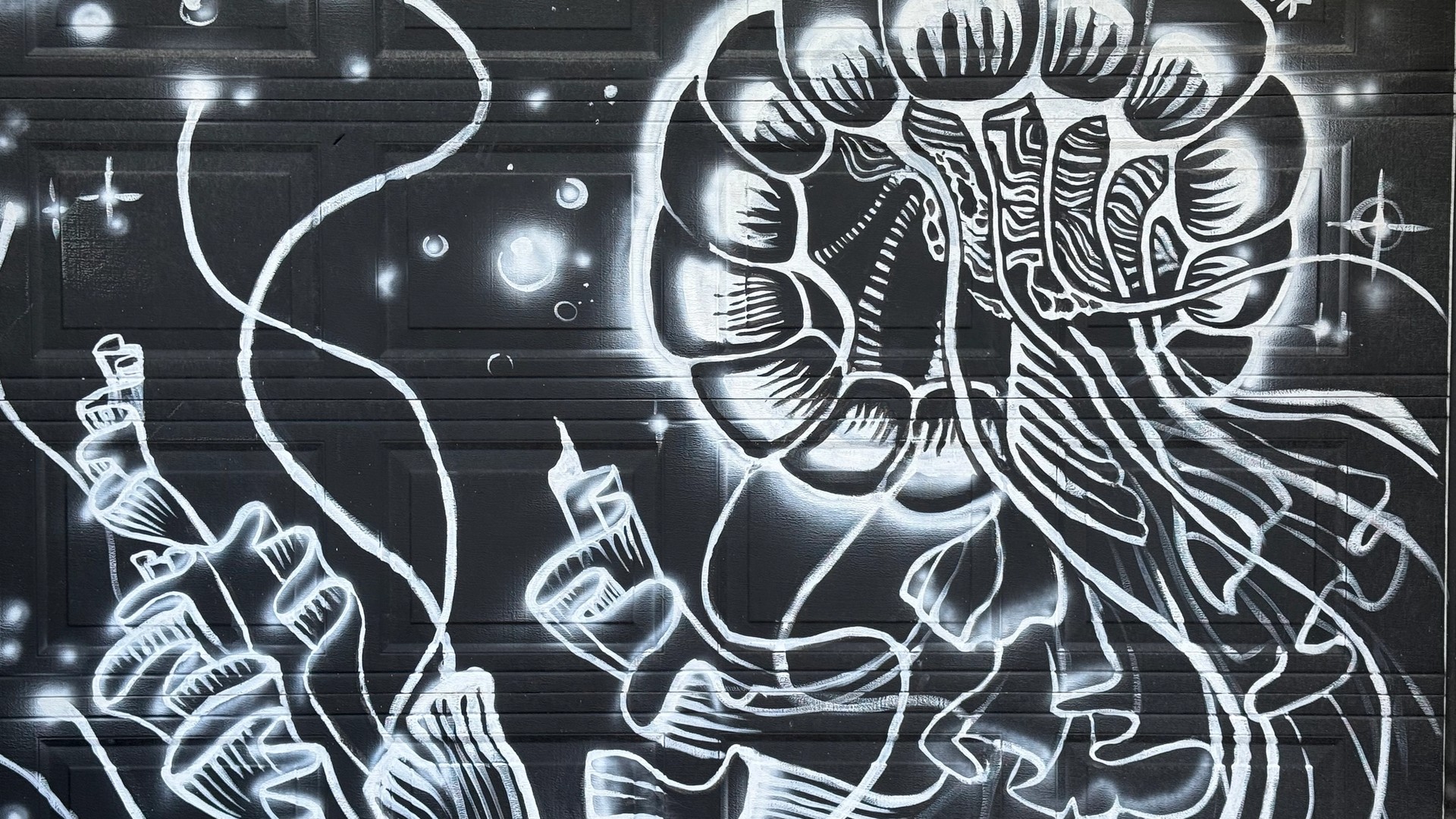 Black and white mural of a detailed jellyfish by Kina Ink. Located in Hintonburg, Ottawa.