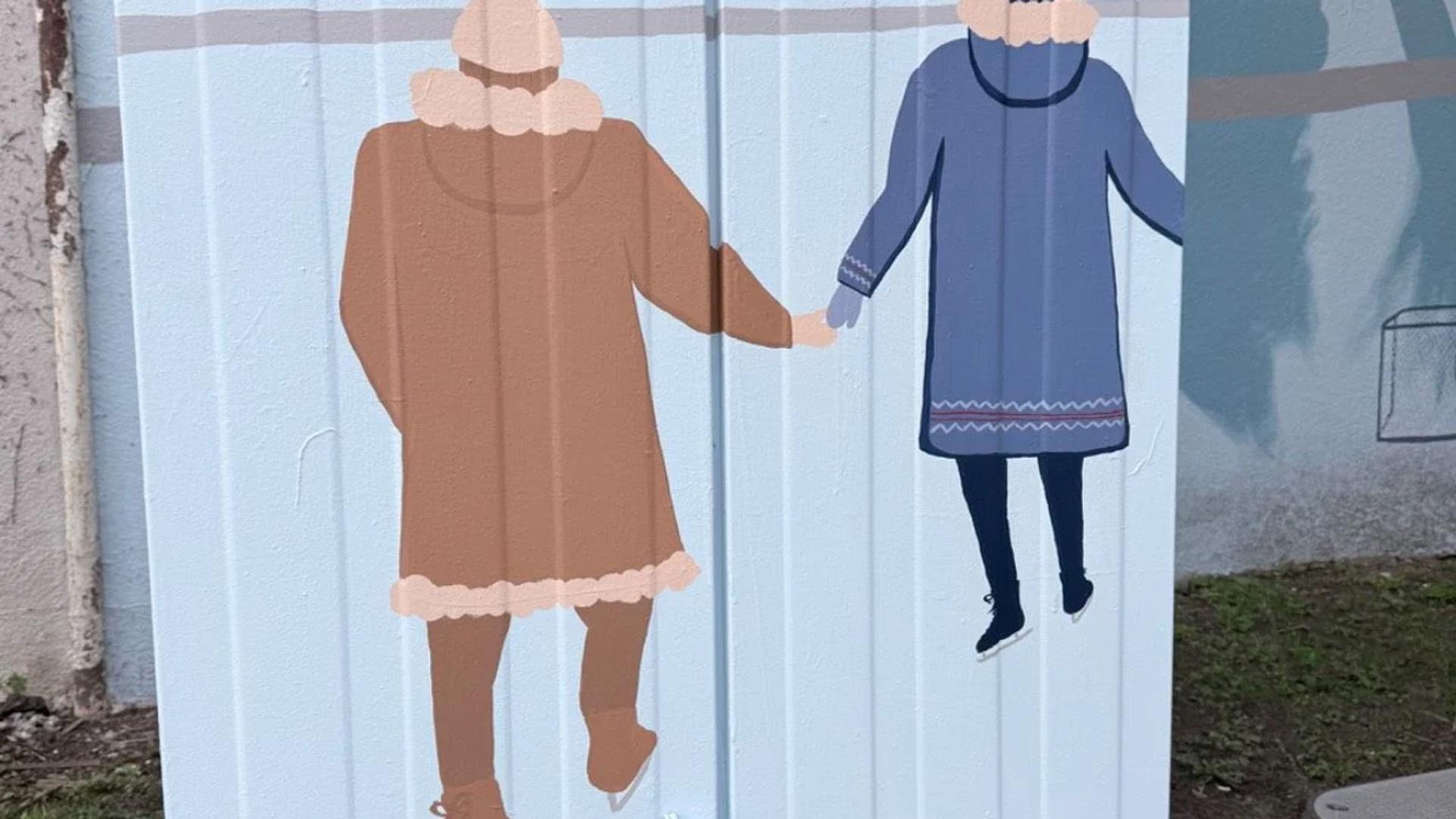 Two figures in winter coats ice skate, holding hands, on a utility box mural with a sunset sky background, 724 Bank Street, Ottawa.
