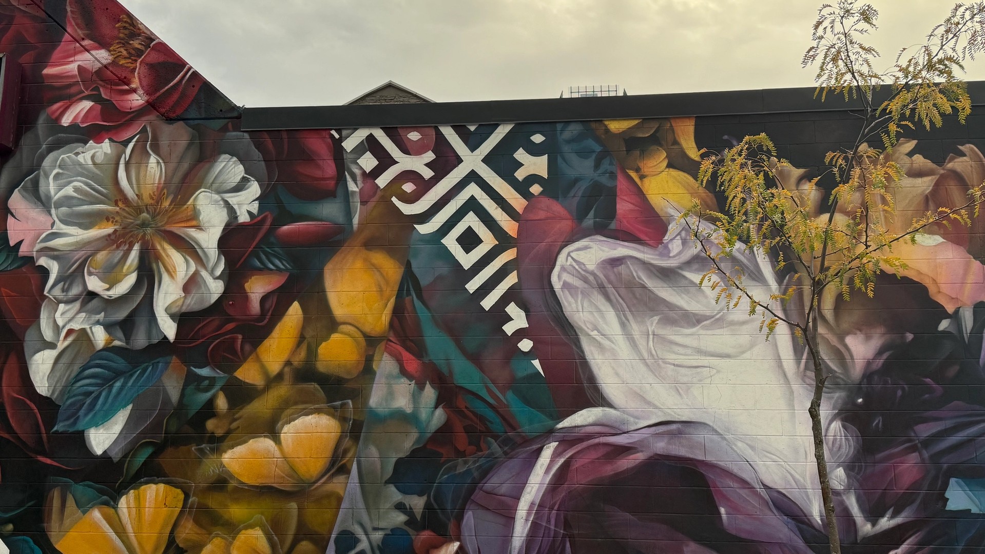 Toujours en mouvement mural in Lowertown by Dom Laporte