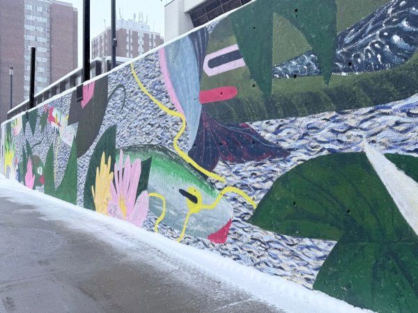 Modern abstract mural Pond in Ottawa featuring bold rippling water patterns and vibrant colors on an urban wall.