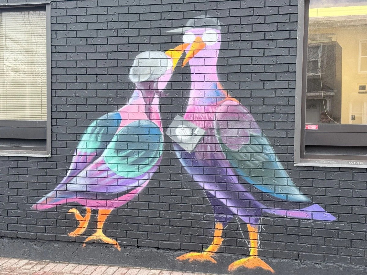 Hintonburg mural "Pigeon People" by Mique Michelle for the Urban Art Collective (UAC), featuring large-scale, colorful figures and collaborative Ottawa street art.