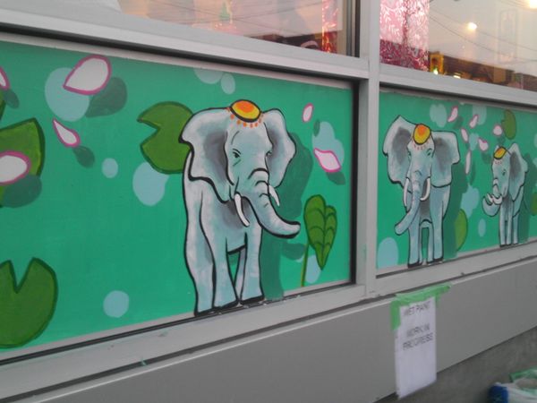 Two-panel mural by Maya Hum featuring colorful elephants on Somerset St West, Chinatown.