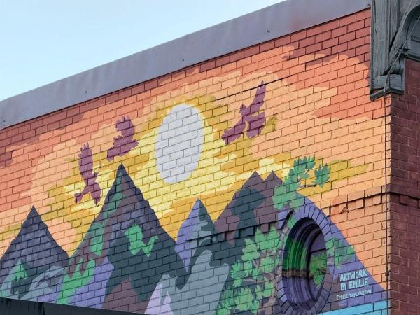 Artwork by Emilie Darlington in Chinatown, Ottawa featuring a bright sun and eagles