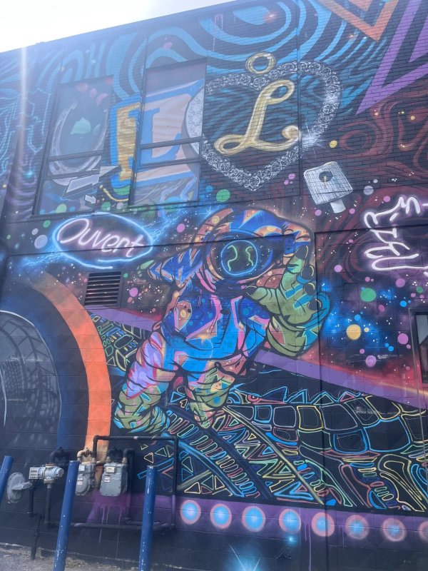 C'est la vie mural featuring a stop sign and urban patterns. Painted by Phil Landry and Marin Mitrasinovic.