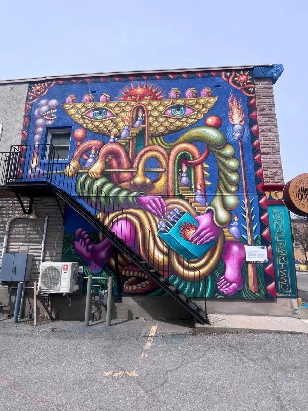 Surrealist mural by artist Danae Brissonnet titled 'The Matchstick Girl' located in Hull. A symbolic, poetic tribute to the E.B. Eddy workers, blending industrial architecture with human fragility and labor history in the Ottawa-Gatineau urban art scene.