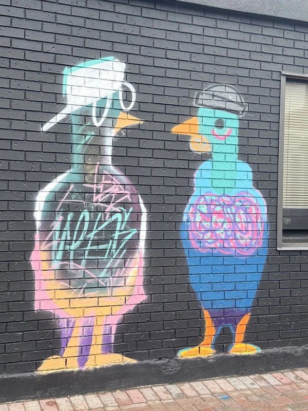 Stylized, graphic figures representing the "Pigeon People" of the Urban Art Collective, a symbolic street art piece celebrating Ottawa's core graffiti community