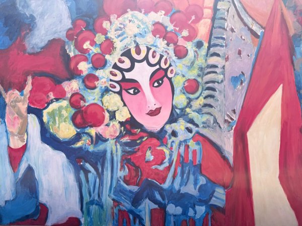 A colorful street mural with a Chinese opera performer illustration and gold text reading "Welcome to Chinatown."