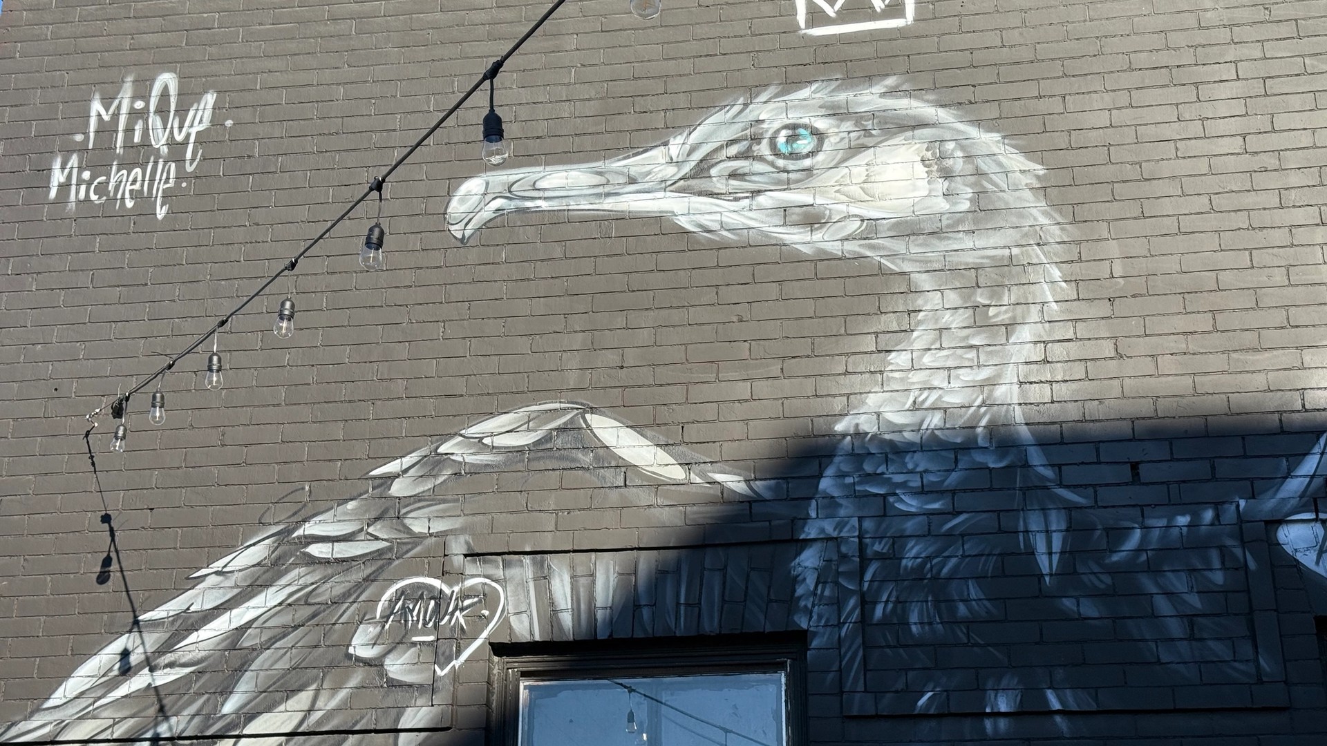 Mural of double crested cormorant by Mique Michelle in Hintonburg. Art from the Urban Art Collective Disrupt 2023.