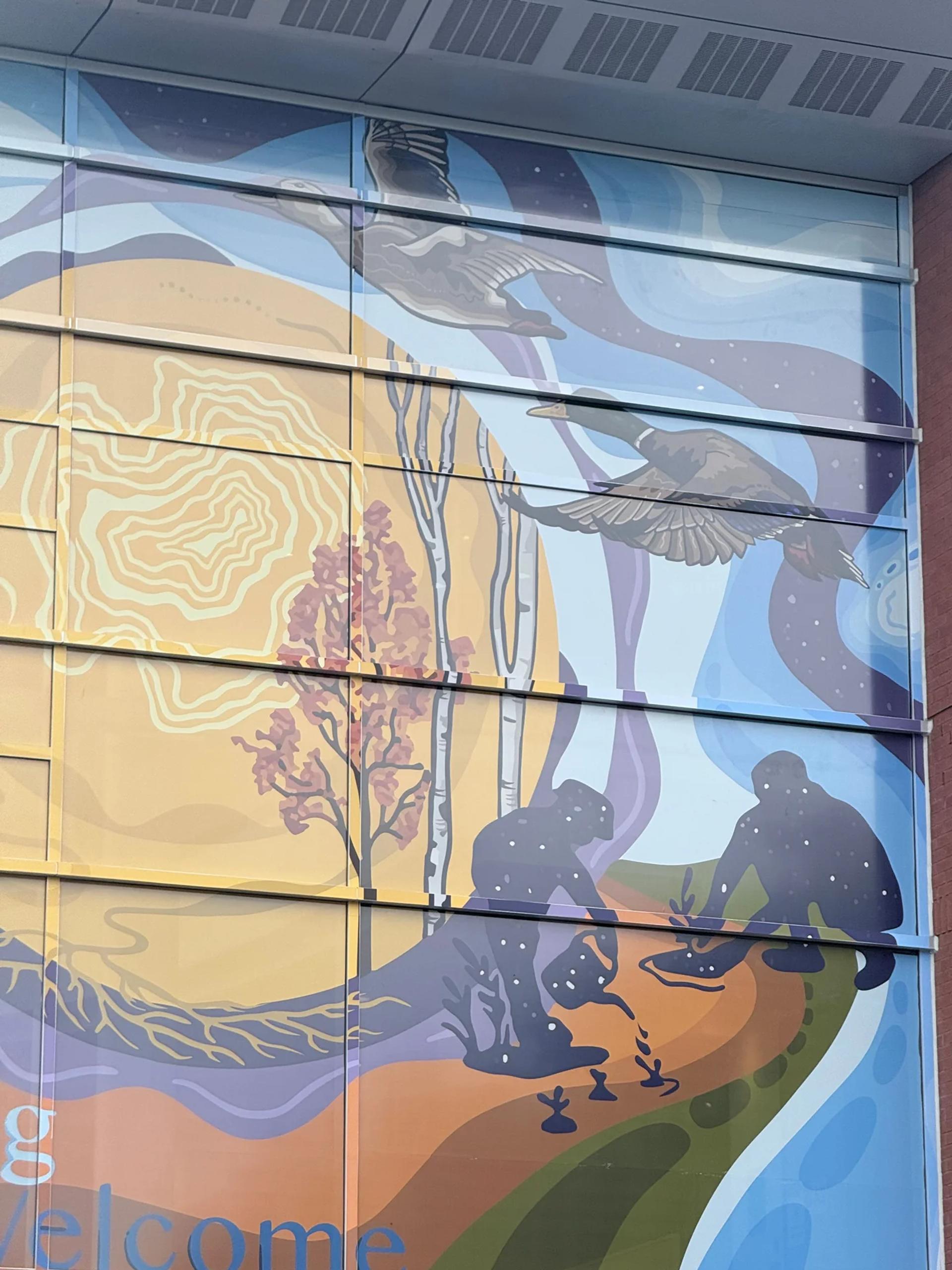 Stylized mural showing two flying ducks above silhouetted figures planting saplings, with autumn trees and abstract patterns in warm and cool tones, Chamberlain Avenue, Ottawa.