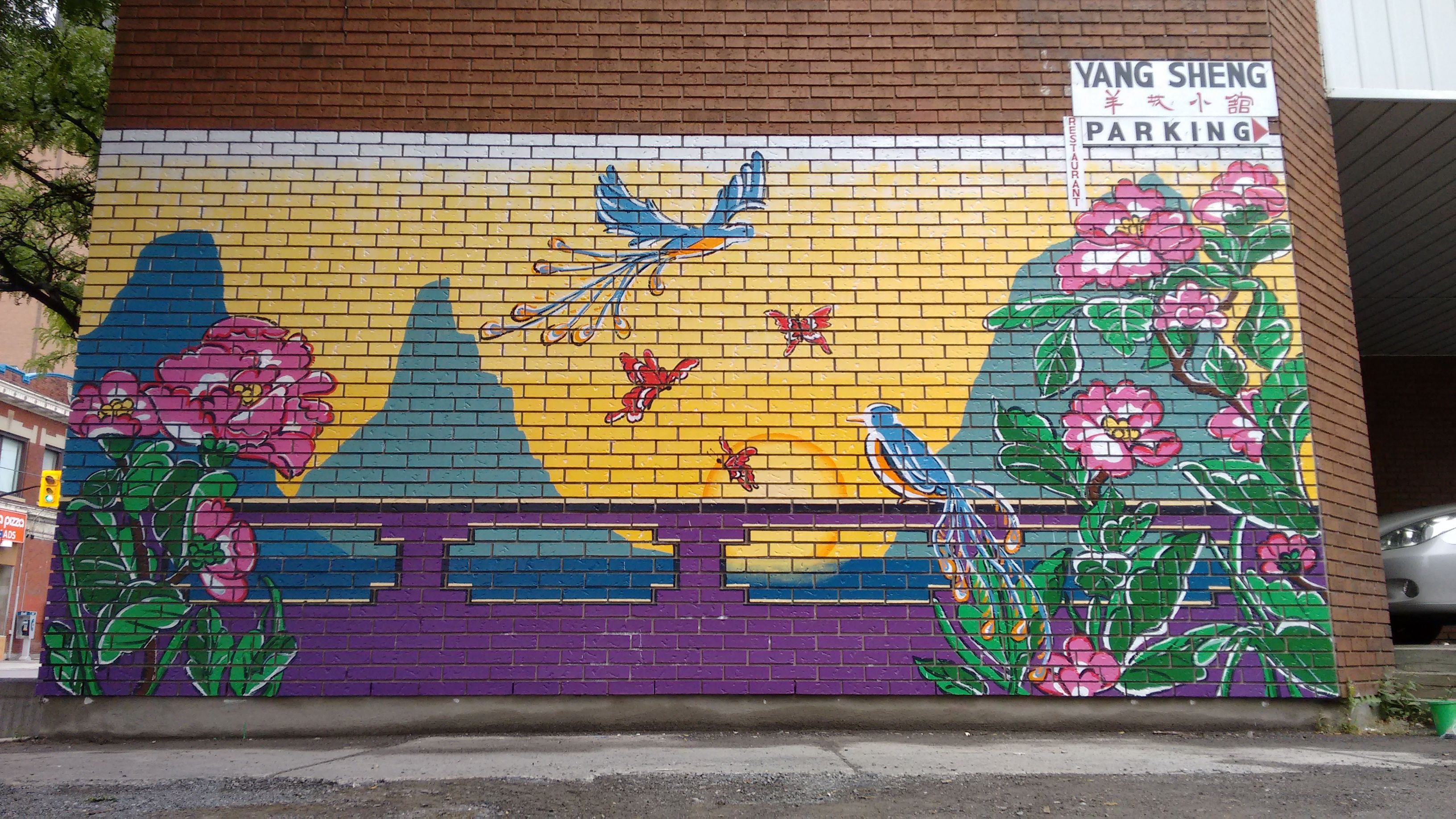 Large, colorful Chinese landscape mural by Maya Hum at Somerset & Bronson, Chinatown Ottawa.