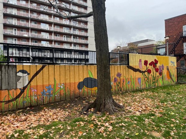 Cheerful birds and dandelion street art on a retaining wall in Centretown. OTTAWALLS Living Art Archive.