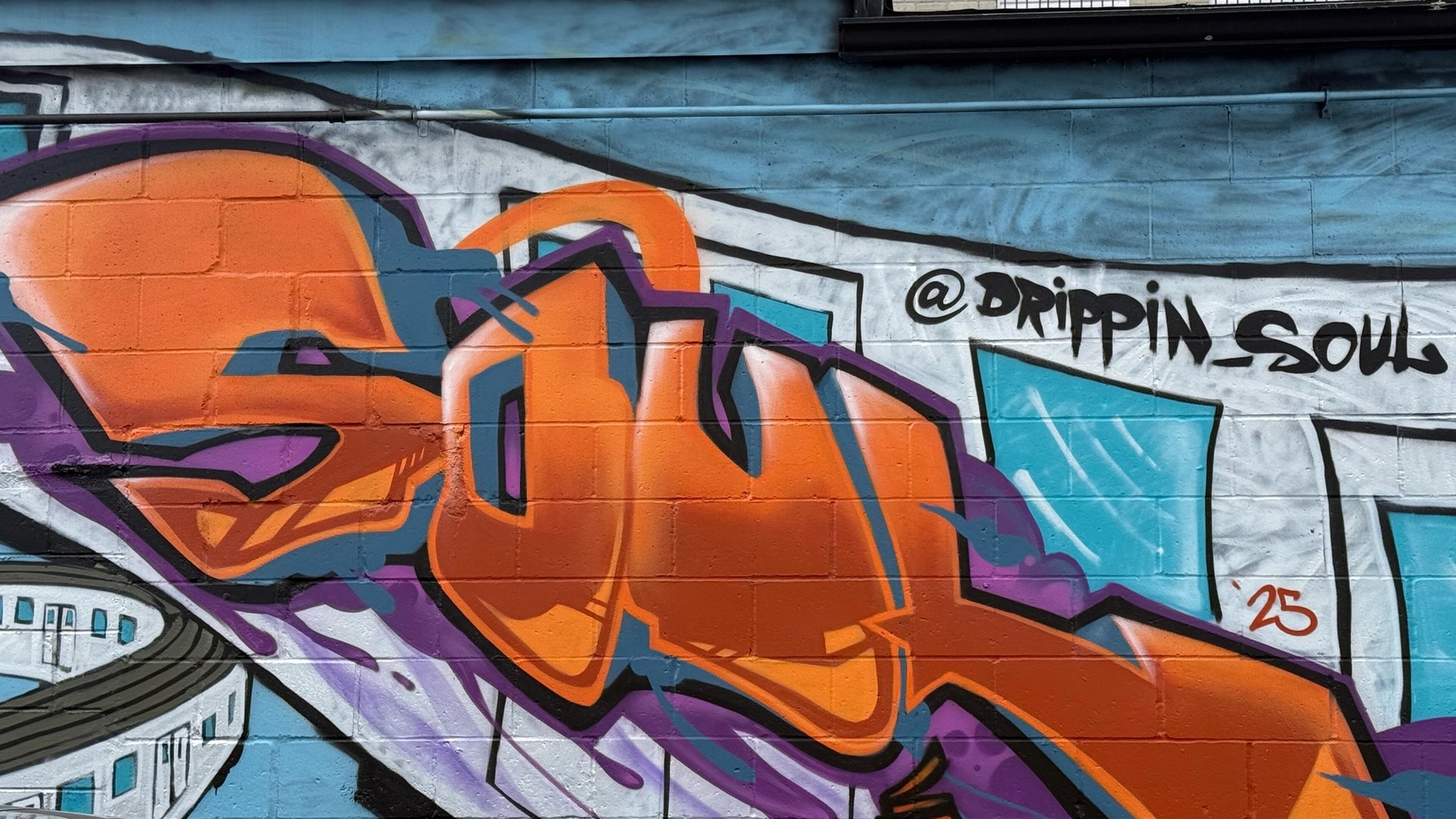 Colorful Kalkidan Assefa mural in Centretown, Ottawa, featuring a stylized train and vibrant, illustrative figures against an urban backdrop.