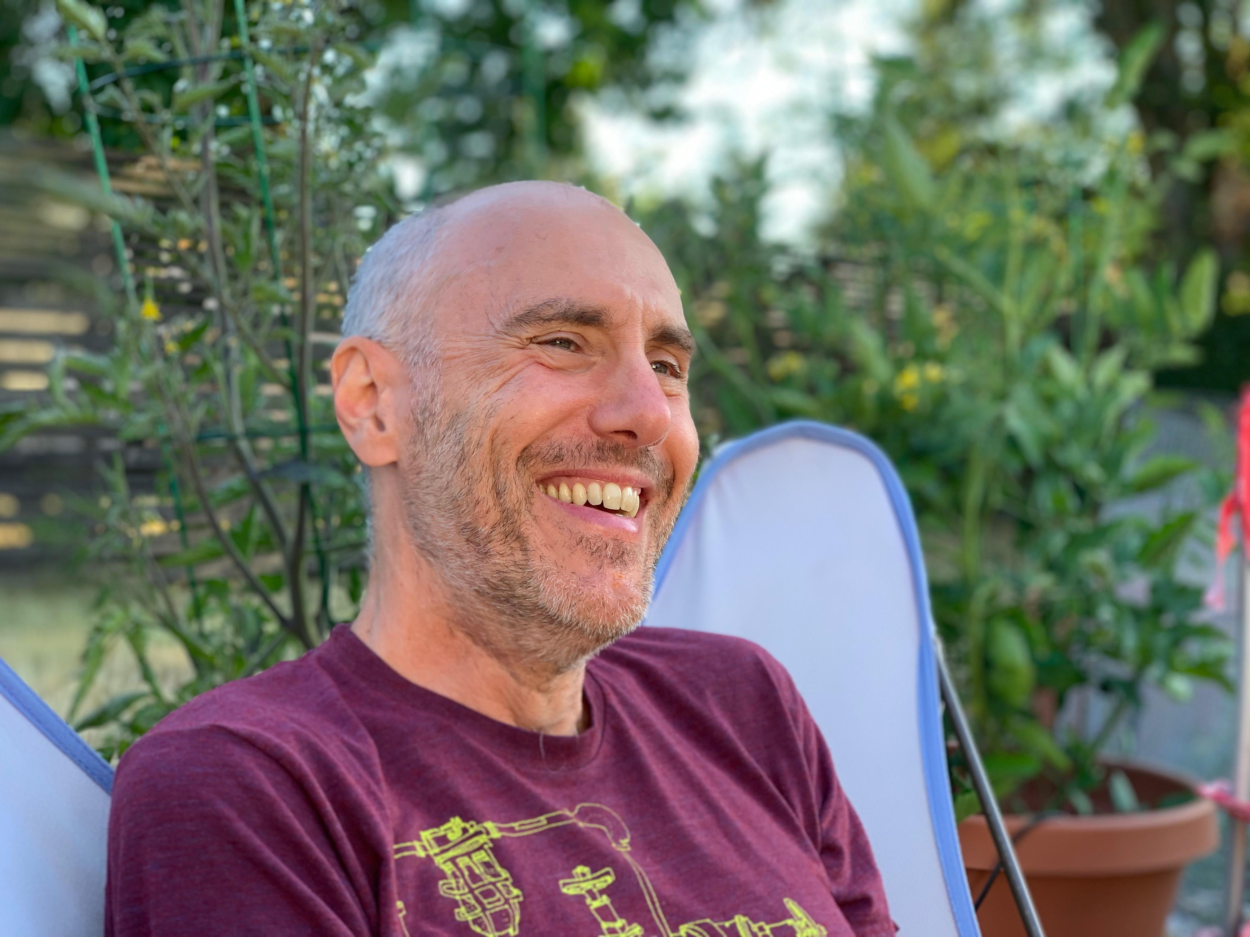 Todd Poremba in a red shirt and smiling.