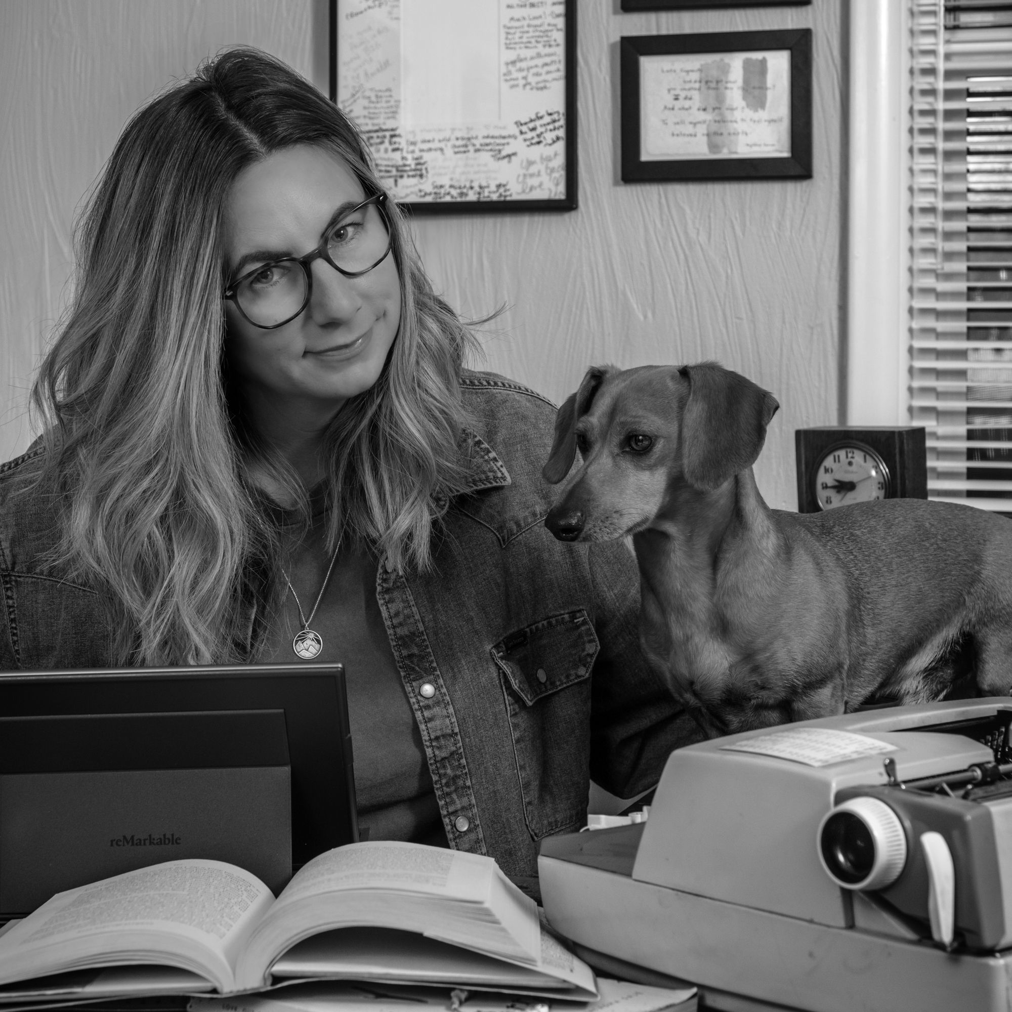 Picture of Brie Goumaz sitting at desk with dachshund