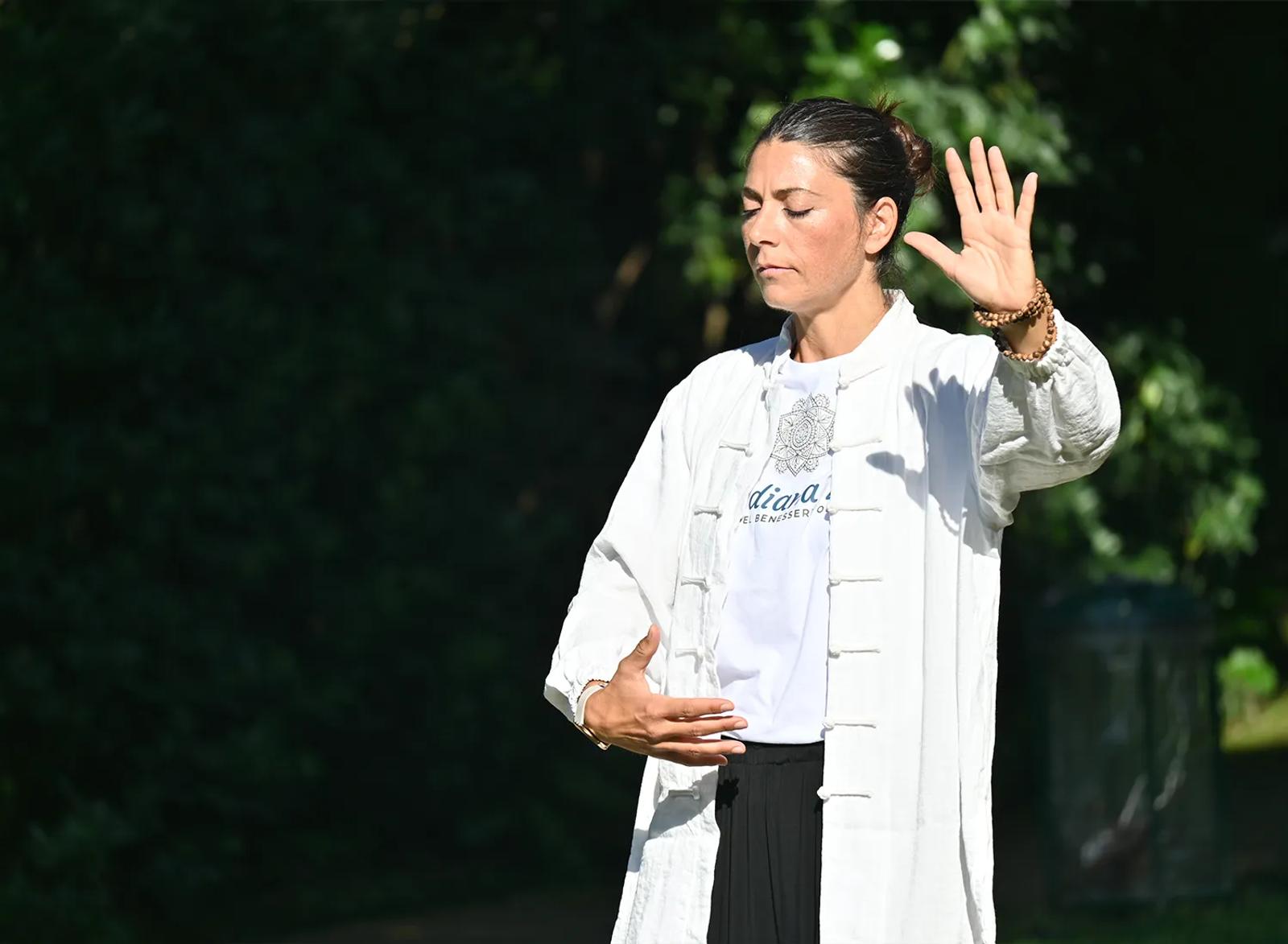 Carolina Inda esegue una postura di Dao Yin immersa nel verde.