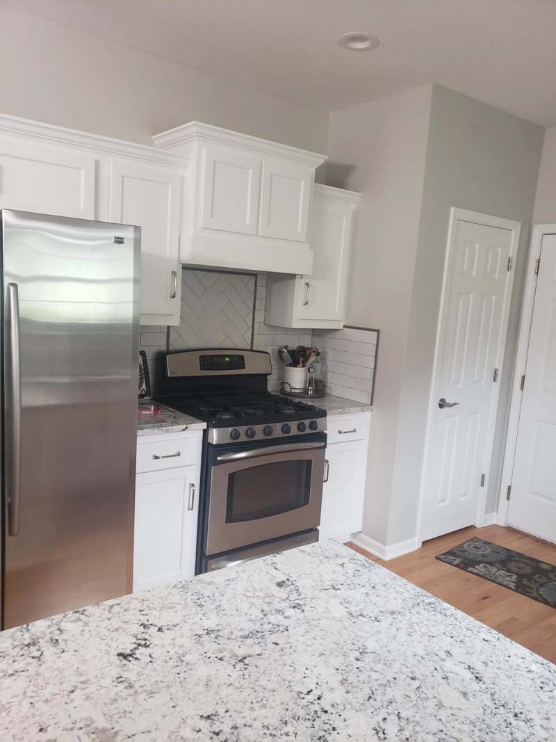 The kitchen from the peninsula, showing the refrigerator wall & new doors on the existing cabinets