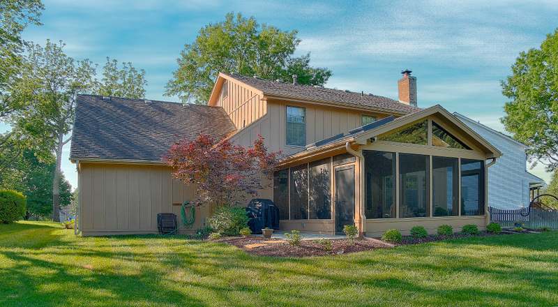 The porch addition seen across the back lawn, tied into the existing roofline
