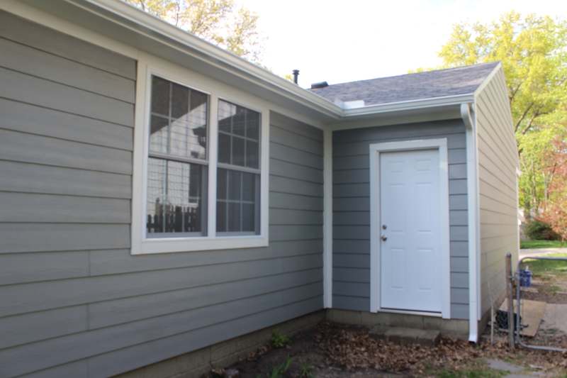 New lap siding & a new exterior door at the rear of the house