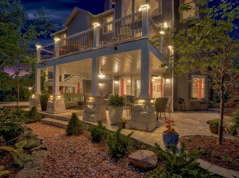 Exterior of a fully remodeled Kansas City home lit at dusk with new siding and windows