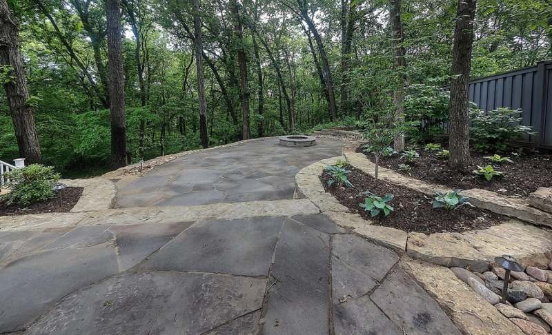 Flagstone walk & patio edged with slab limestone & new planting along the wooded side of the yard