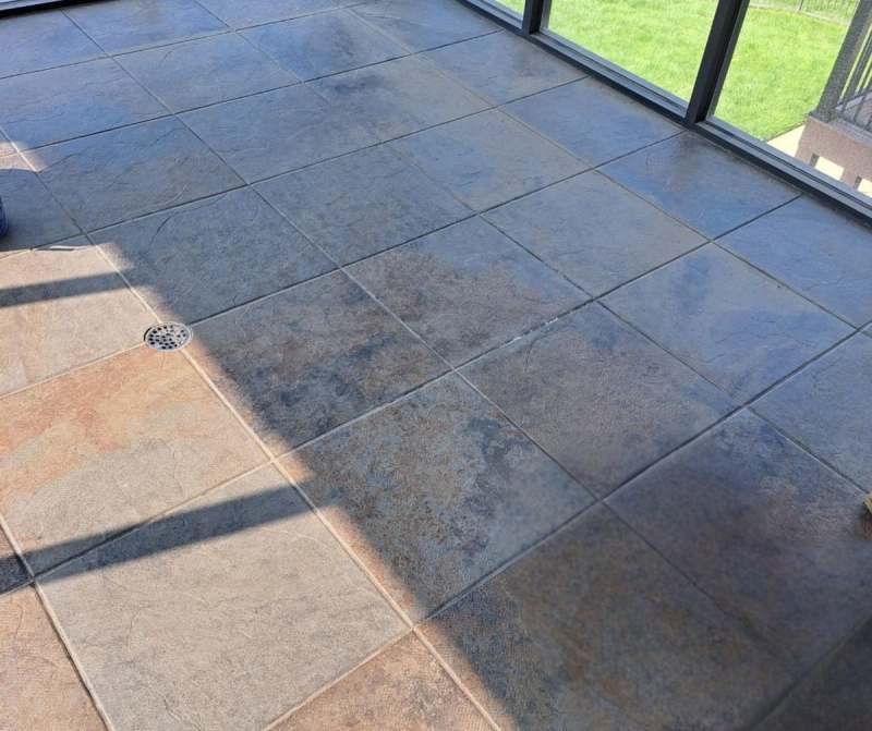 The finished porch floor in large format tile, laid over the rebuilt structure