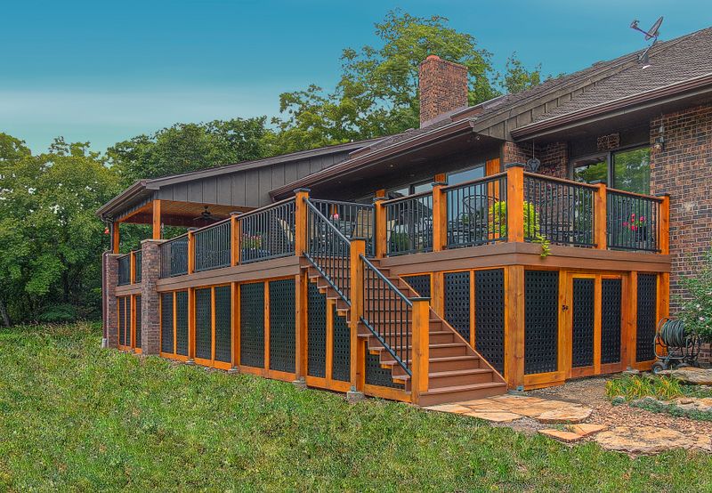 Long glass sunroom addition running the length of a Kansas City home with a deck alongside