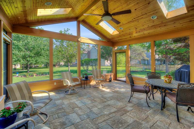 The porch interior looking out through the screen walls to the yard