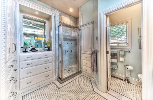 Master bathroom remodel by All Under One Roof with marble tile shower, built-in vanity and custom cabinetry, Kansas City