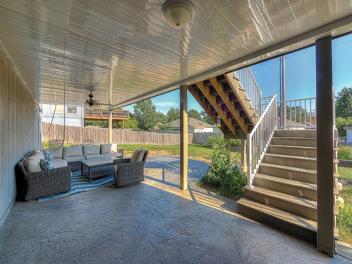 Covered patio by All Under One Roof with stamped concrete and under-deck ceiling system, Kansas City