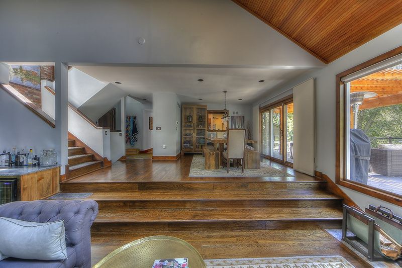 Open main floor with a staircase, wood floors, and long sightlines between living areas