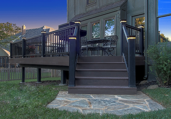 PVC deck by All Under One Roof with lit post caps and flagstone landing, Overland Park, Kansas
