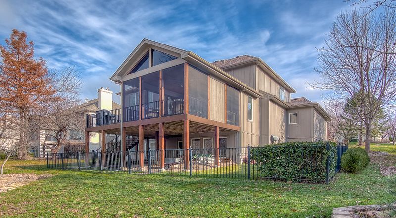 Exterior of a glass sunroom addition built onto the back of a Kansas City home