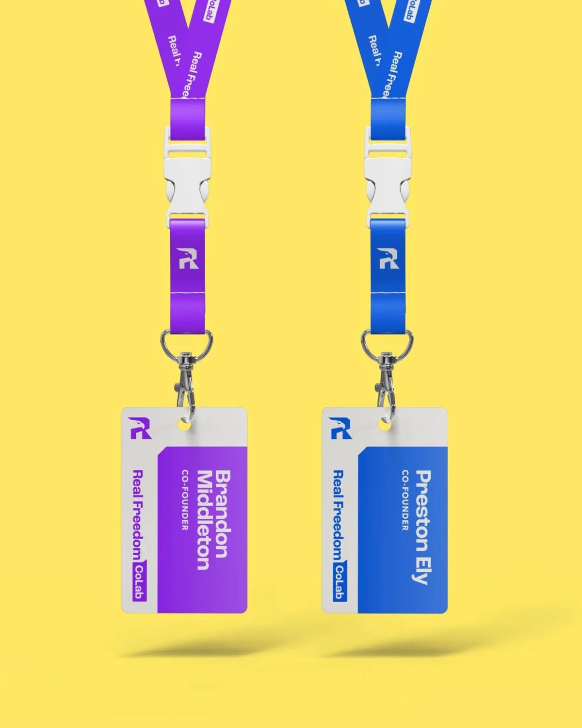 Two Real Freedom CoLab co-founder ID badges on dark green lanyards against yellow
