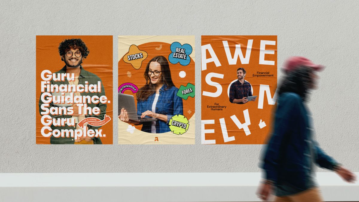 Three orange Awesomely posters on a wall as a person walks past, one reading Guru Financial Guidance