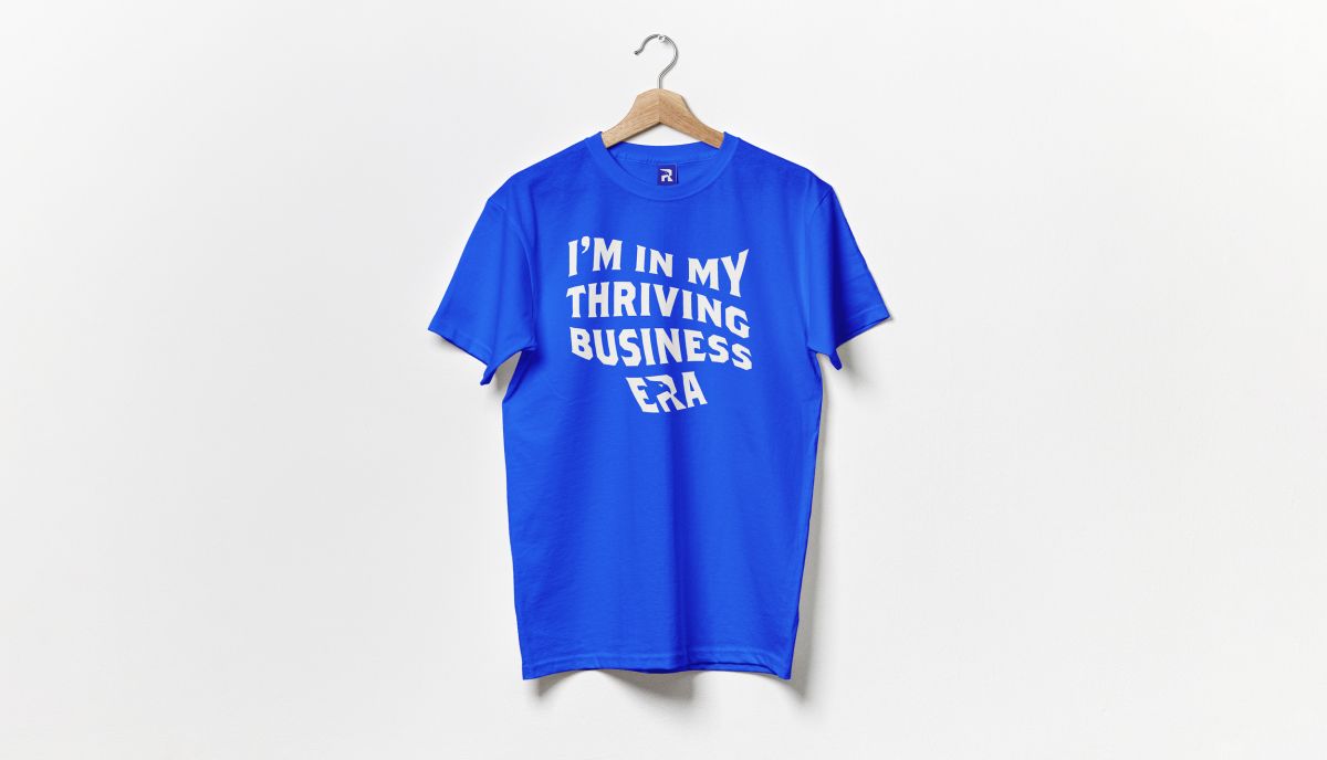 Royal blue Real Freedom t-shirt reading I'm in my thriving business era