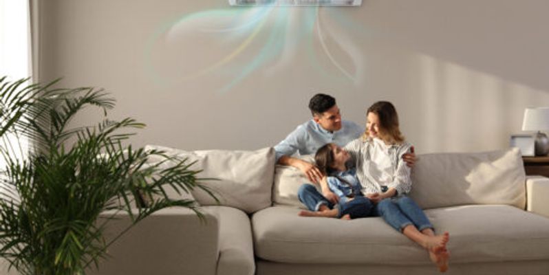 A young family cooling off in a room with a mini-split.