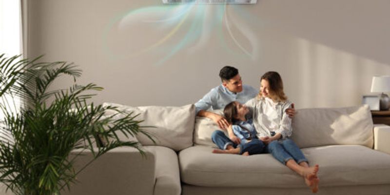 A young family cooling off in a room with a mini-split.