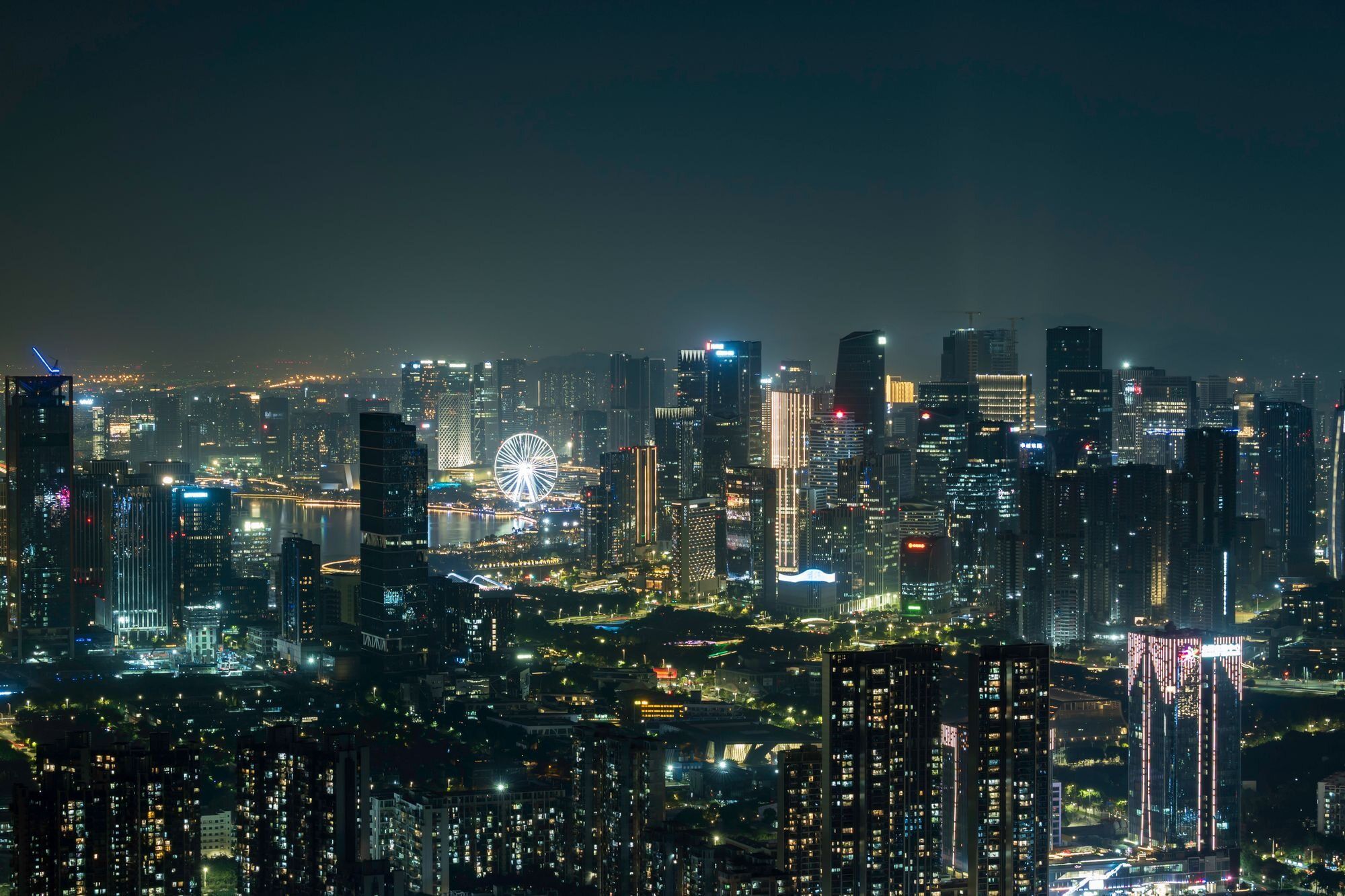 The Bay Glory observation wheel lit at night over Shenzhen's western bay