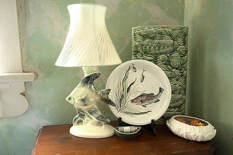 a fish plate and lamp on a table