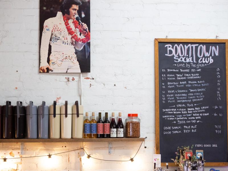 a photo of Elvis next to a drinks list on a wall