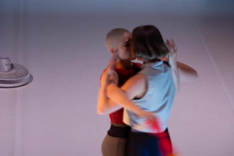 two dancers embrace as they are spinning