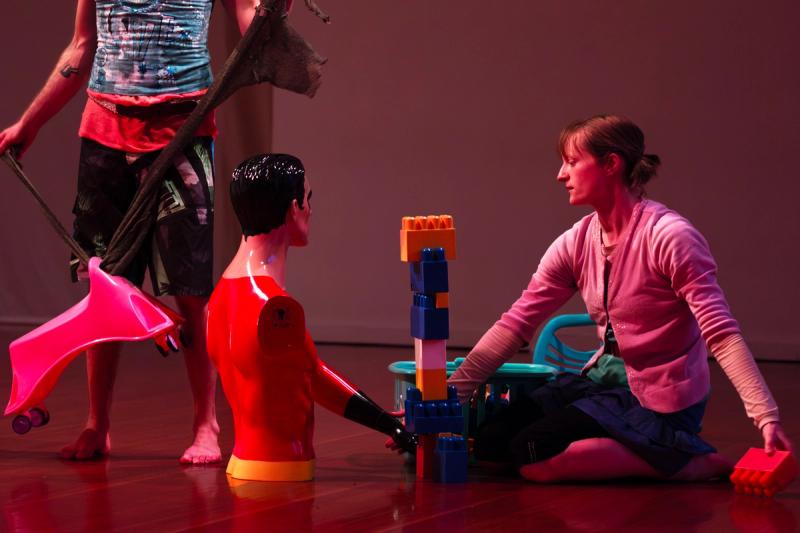 two performers play with toys