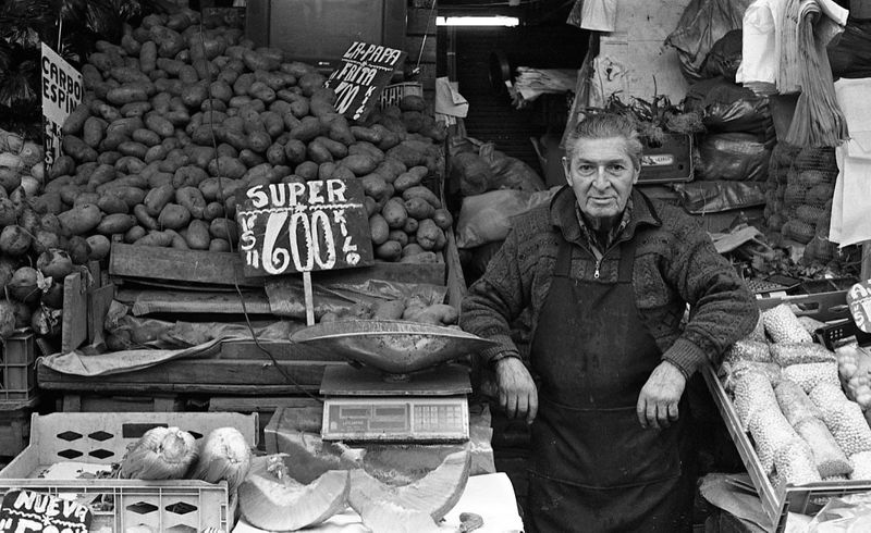a market stall owner poses with his produce