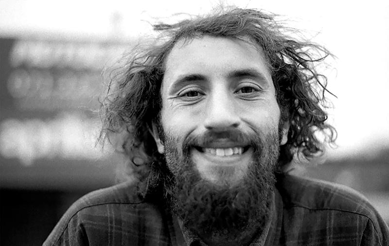 a black and white portrait photo of José Patricios smiling