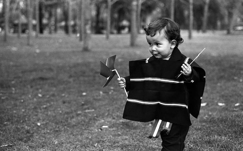 a black and white photo of a child in traditional chilean clothing on chilean Independence Day 